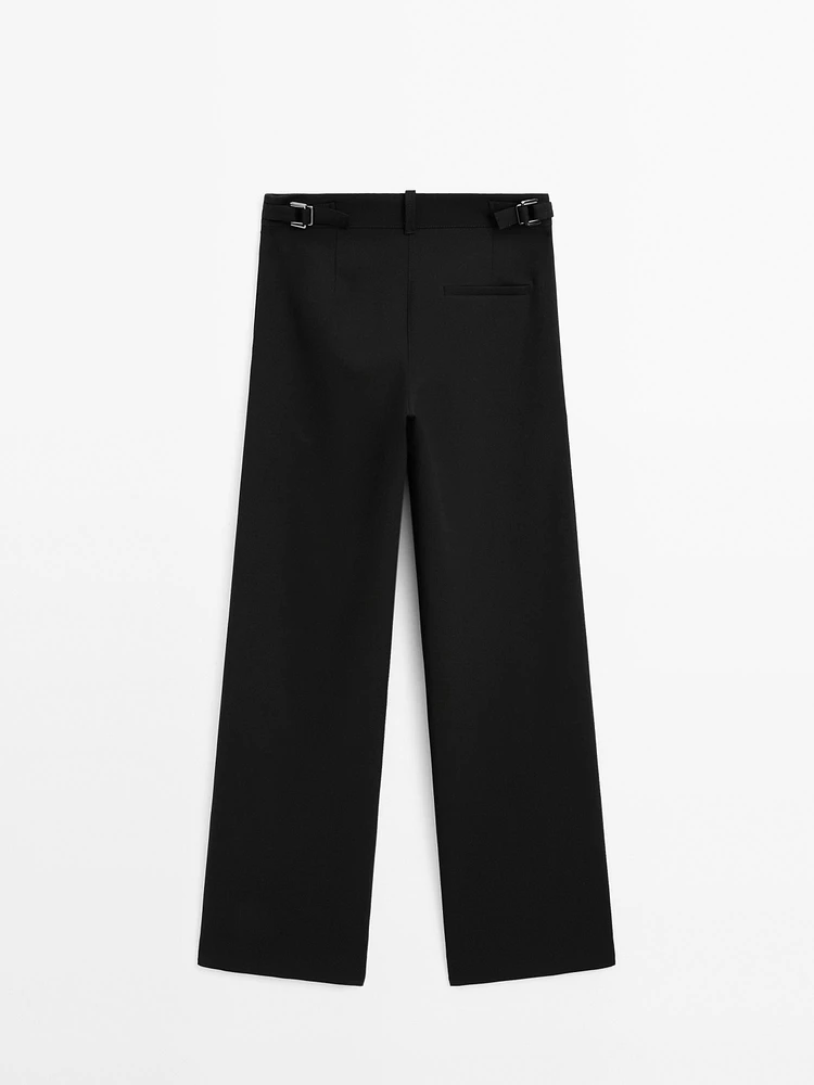 Flowing mid-waist trousers with buckles