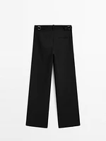 Flowing mid-waist trousers with buckles