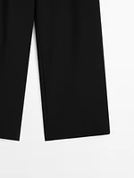 Flowing mid-waist trousers with buckles