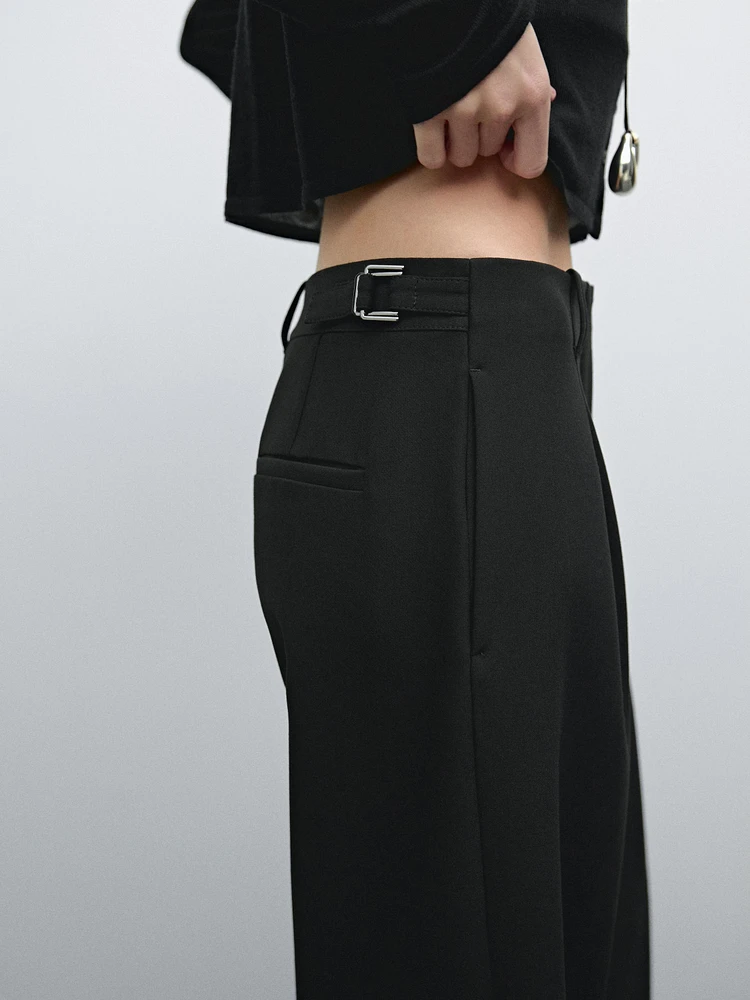 Flowing mid-waist trousers with buckles