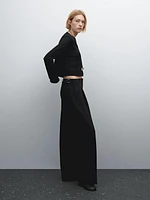 Flowing mid-waist trousers with buckles