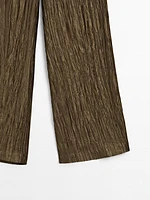 Trousers with metallic fabric detail