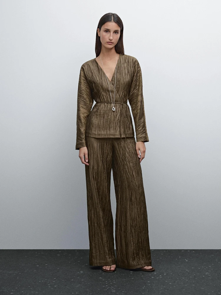 Trousers with metallic fabric detail