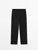 Trousers with buttoned hems