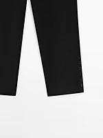 Trousers with buttoned hems