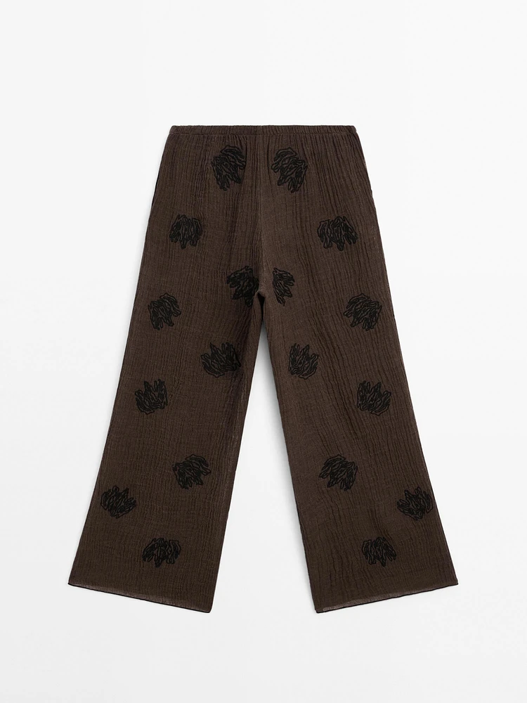 Flowing textured trousers with embroidered detail
