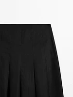 Midi skirt with asymmetric pleats