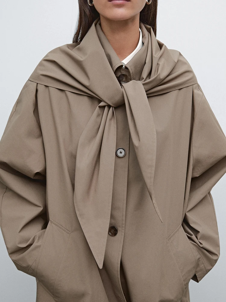 Trench coat with detachable scarf detail