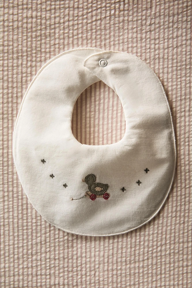 CHILDREN'S BIB WITH DUCKLING APPLIQUÉS