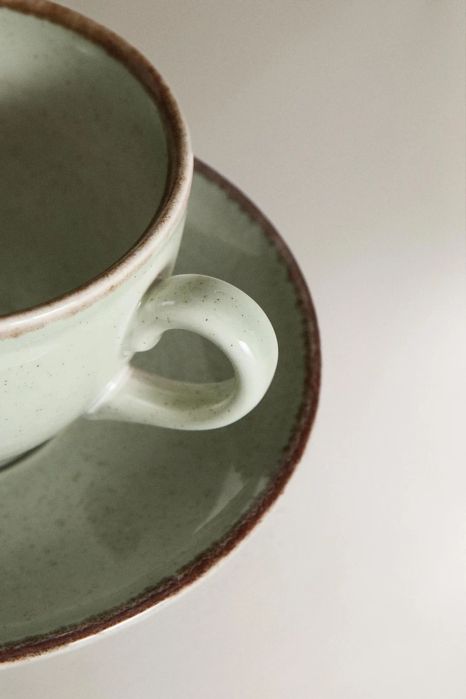 PORCELAIN TEACUP WITH ANTIQUE FINISH RIM