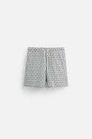 REGULAR FIT GEOMETRIC PRINT SWIM TRUNKS