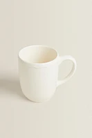 EARTHENWARE MUG WITH A RAISED-DESIGN EDGE