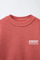 SWEAT EFFET DÉLAVÉ À INSCRIPTION IMPRIMÉE