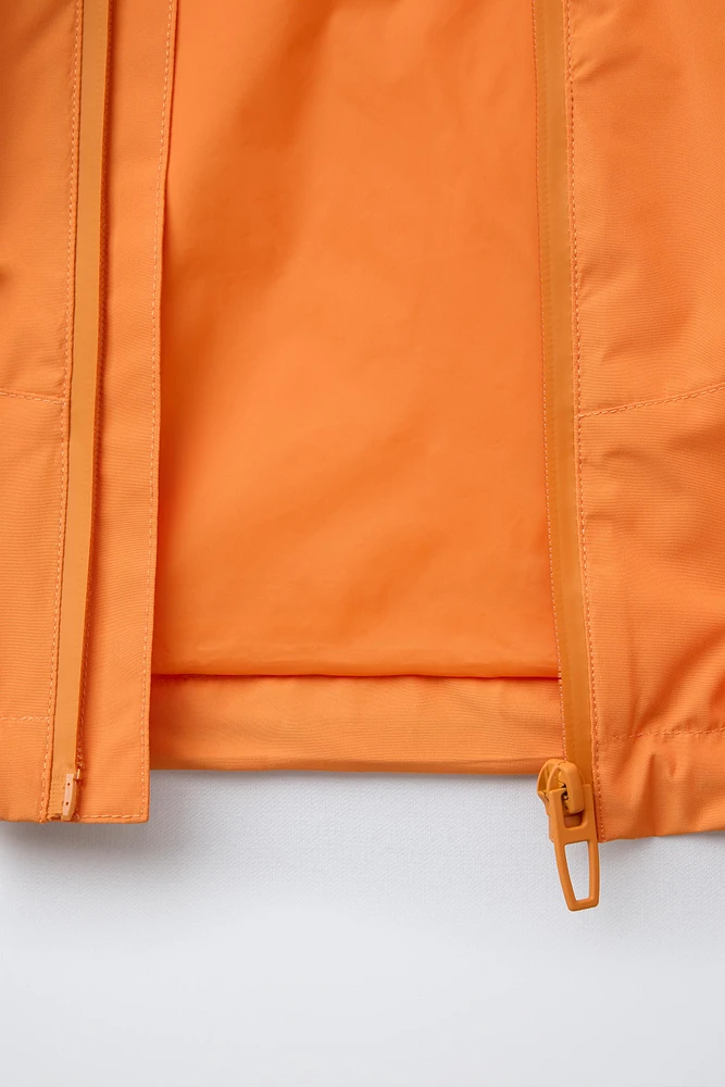 VESTE LÉGÈRE À CAPUCHE DÉPERLANTE