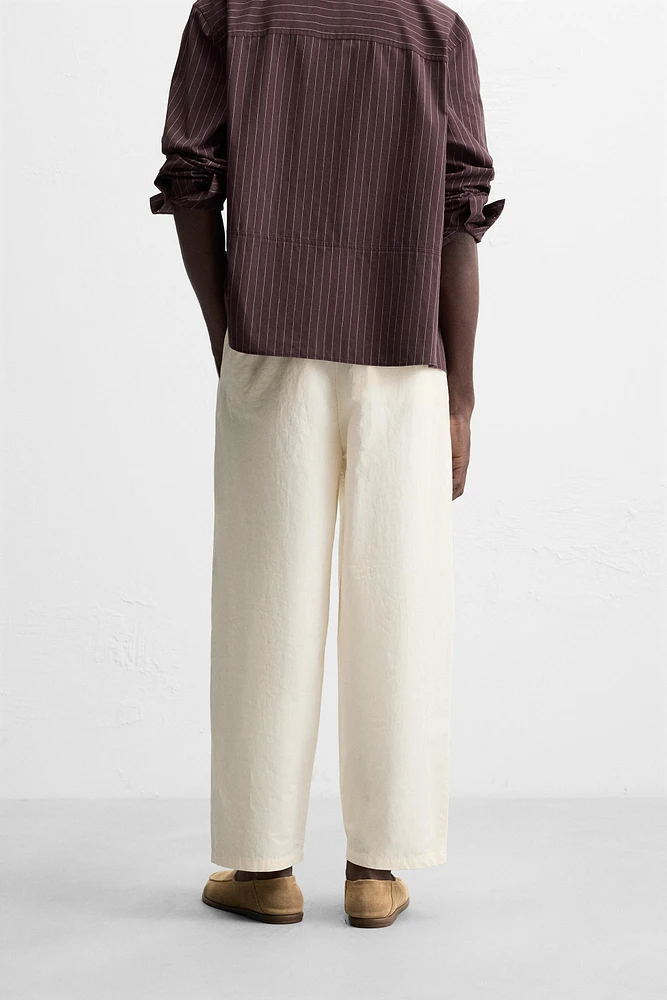 PLEATED CHINO PANTS