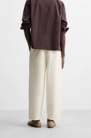 PLEATED CHINO PANTS