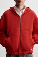 VESTE STRUCTURE OUVERTE CAPUCHE