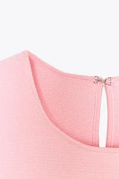 TIE-DETAIL PEPLUM KNIT TOP
