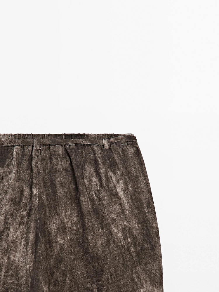 Distressed-effect flared trousers