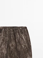 Distressed-effect flared trousers