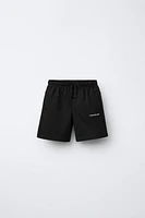 RAISED TEXT PLUSH SHORTS