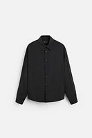 Relaxed fit shirt made of modal blend fabric. Lapel collar and long sleeves with buttoned cuffs. Front button closure.