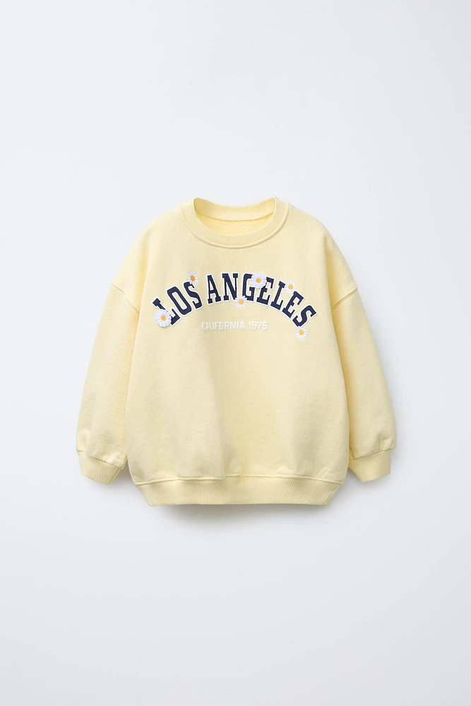 RAISED TEXT DAISY SWEATSHIRT