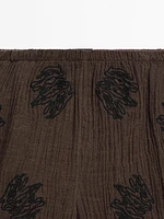 Flowing textured trousers with embroidered detail