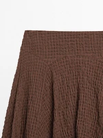 Jupe fluide à carreaux bas asymétrique