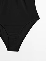 Bandeau swimsuit with metal piece detail