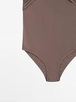 Bandeau swimsuit with criss-cross straps