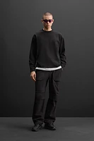 Relaxed fit T-shirt. Round neck and long sleeves with ribbed cuffs. Matching tonal embroidery at front.<br/><br/>Zara Athleticz.