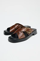 LEATHER CRISS CROSS BUCKLE SANDALS