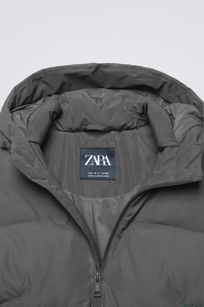 MANTEAU DÉPERLANT ÉTIQUETTE