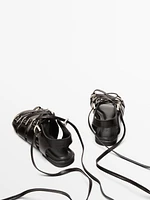 Lace-up sandals with rings