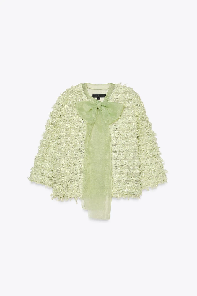 GILET EN MAILLE À FRANGES AVEC LACET ORGANZA