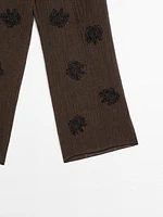 Flowing textured trousers with embroidered detail