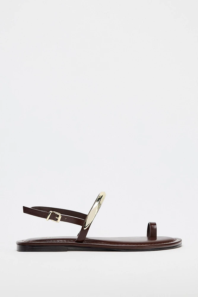 FLAT SANDALS WITH METAL APPLIQUÉ