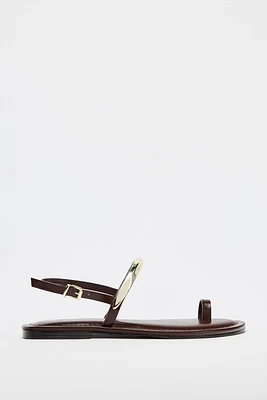 FLAT SANDALS WITH METAL APPLIQUÉ
