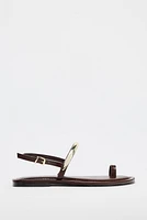 FLAT SANDALS WITH METAL APPLIQUÉ