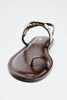 FLAT SANDALS WITH METAL APPLIQUÉ