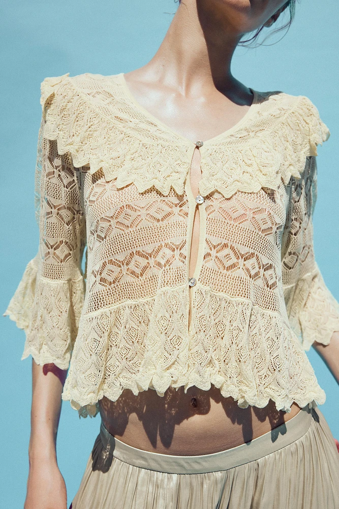 BLOUSE EN MAILLE POINTELLE À VOLANTS