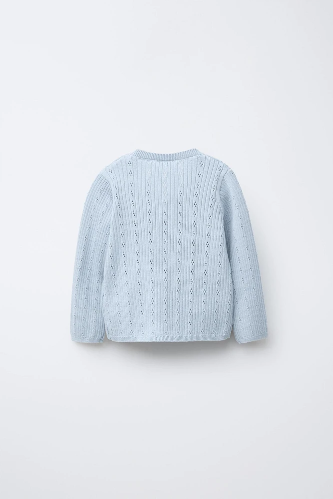 GILET EN MAILLE CROISÉ AJOURÉ