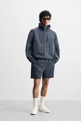 BLOUSON TECHNIQUE À CAPUCHE