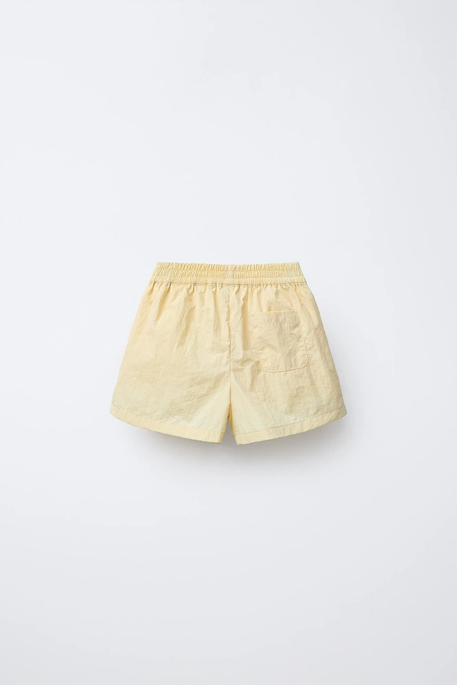 JUPE-SHORT TECHNIQUE À PLIS PLATS