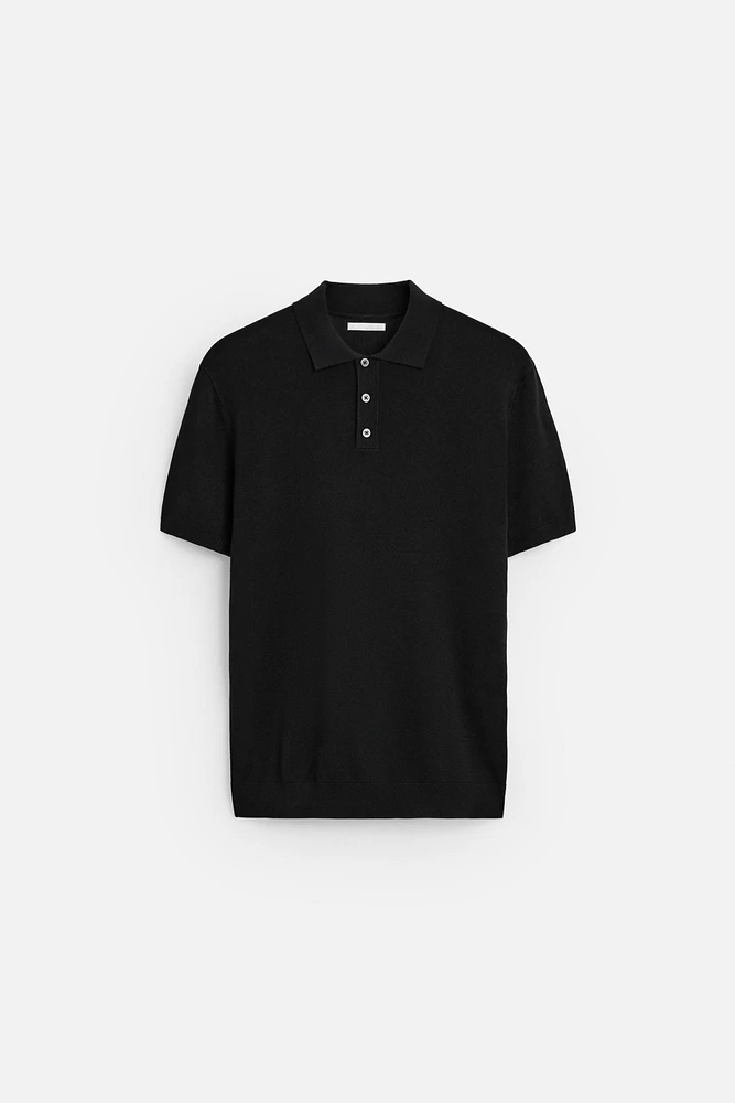 Knit polo shirt viscose blend fabric. Lapel collar with front button closure. Short sleeves. Side vents at hem. Rib trim.