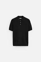 Knit polo shirt viscose blend fabric. Lapel collar with front button closure. Short sleeves. Side vents at hem. Rib trim.