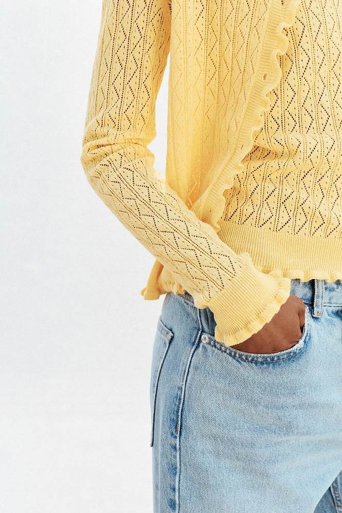 GILET EN MAILLE POINTELLE À VOLANTS