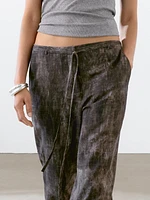 Distressed-effect flared trousers