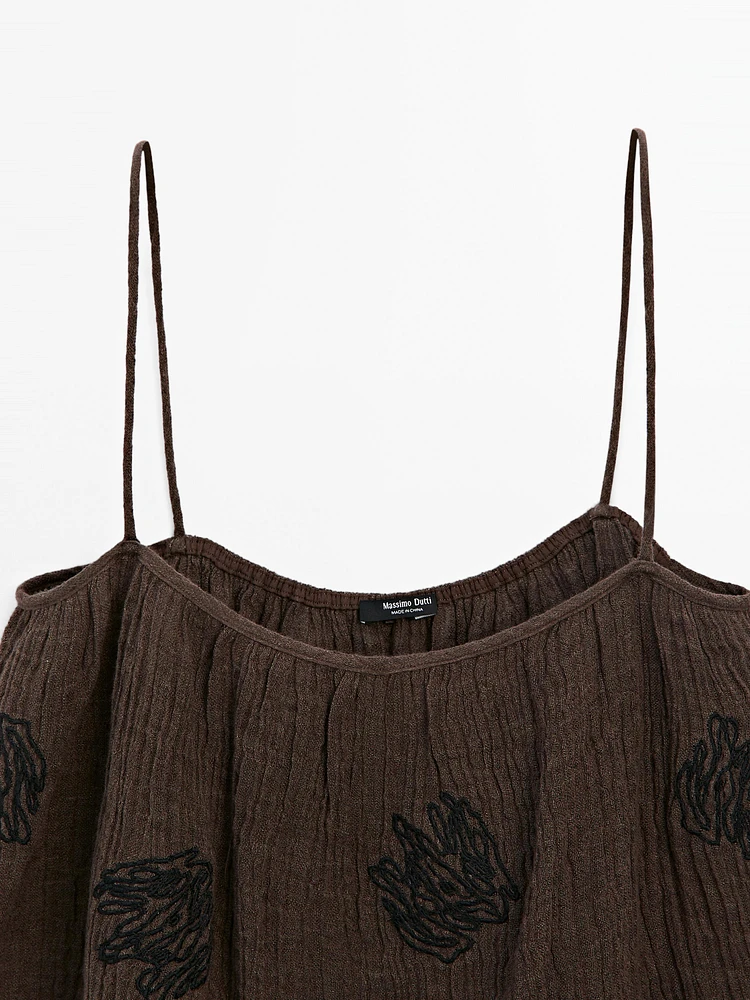 Flowing textured top with embroidered detail